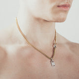 Man wearing gold chain necklace with rectangular six-sided silver tag pendant   and silver carabiner clasp
