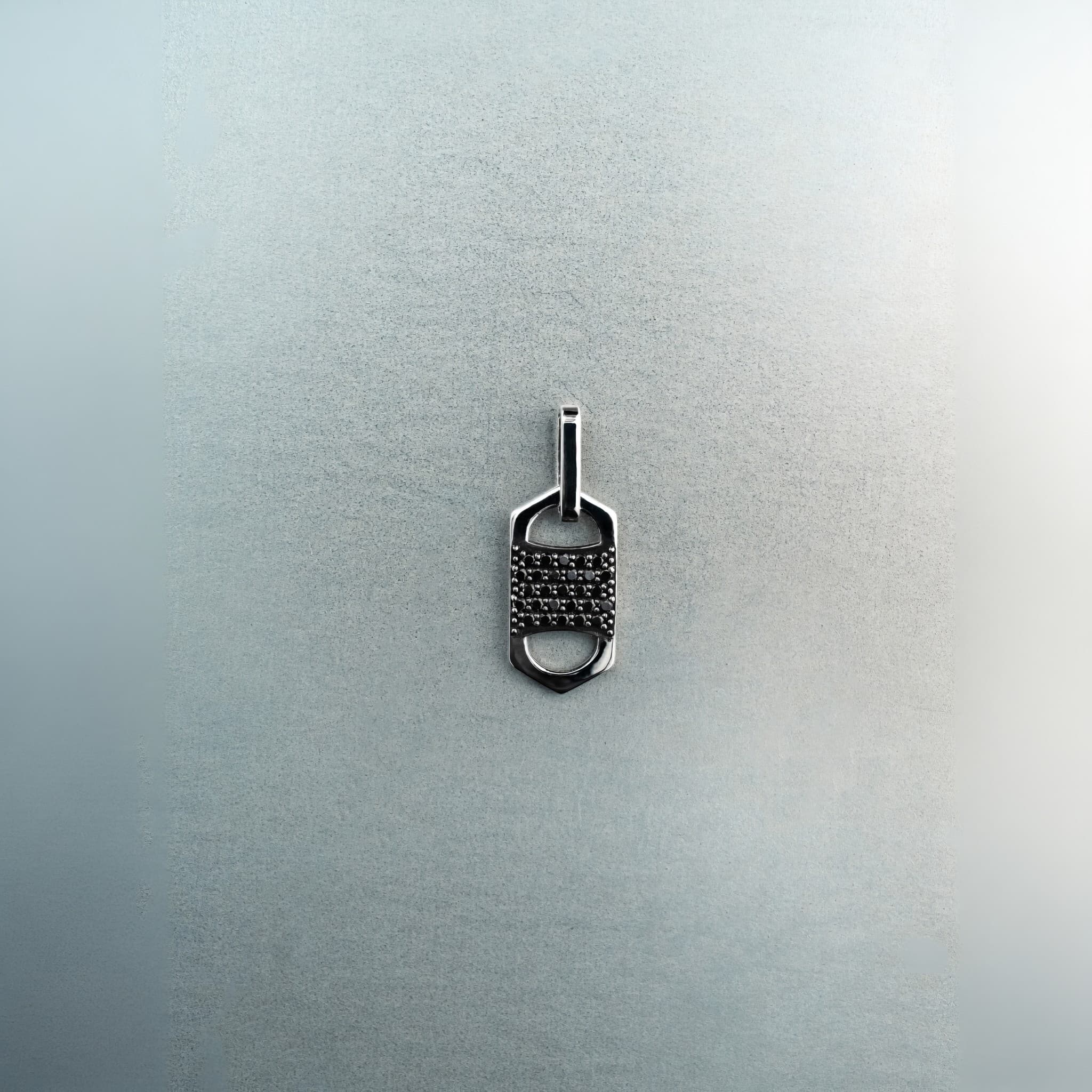 Rectangular six-sided silver tag pendant with centered diamond cluster, top and bottom cutout details, and jump ring
