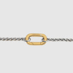 A close-up of a gold-tone carabiner clasp connected to a silver-tone chain, shown against a light gray background. The brand name 'LOCKSET' is engraved on the gold clasp.