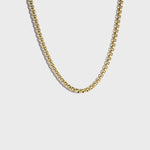 Thick gold rolo chain necklace on white background
