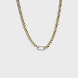 Thick gold rolo chain necklace with silver carabiner clasp on white background