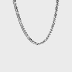 Thick silver rolo chain on white background