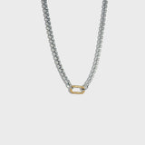 Thick silver rolo chain necklace with gold carabiner clasp on white background