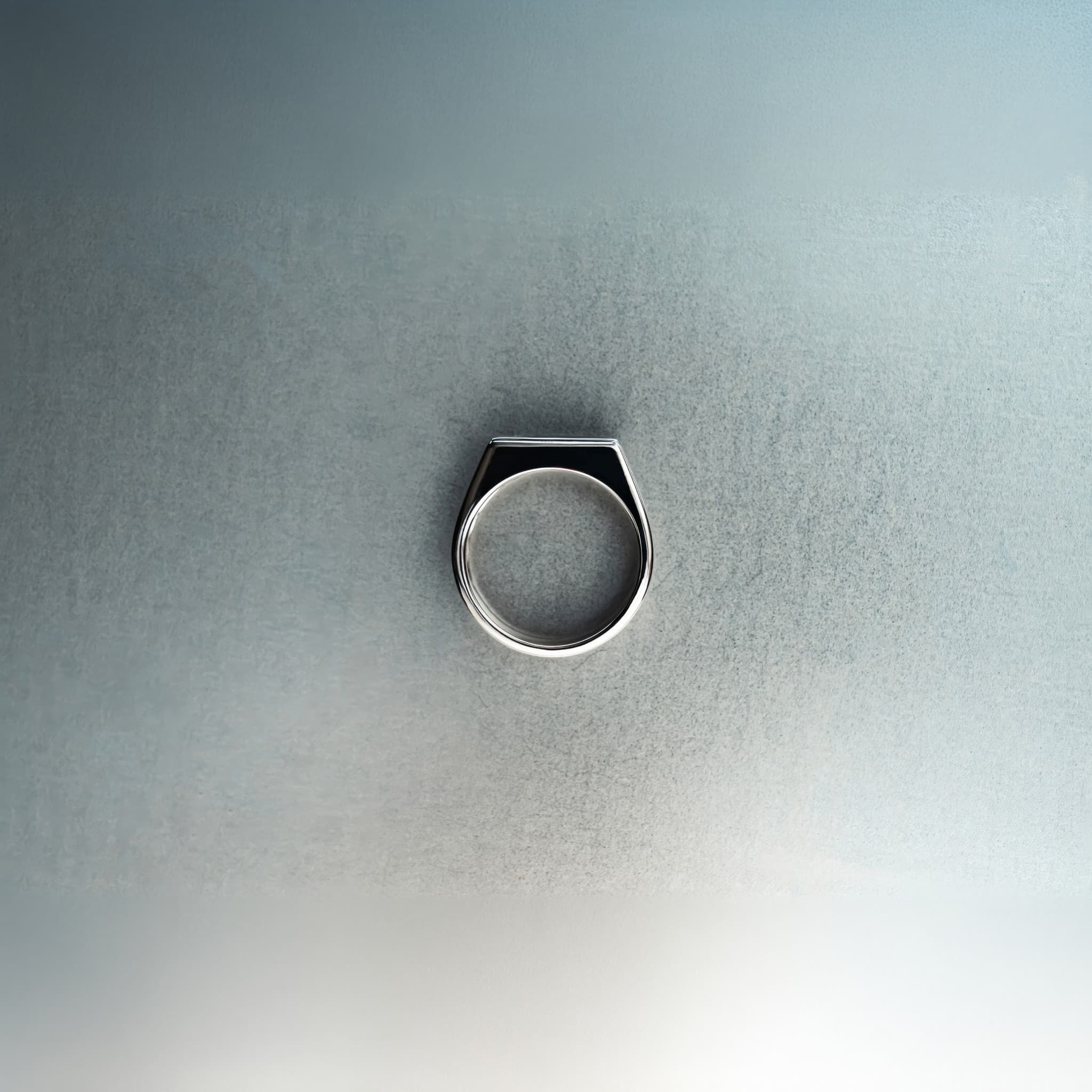 Silver ring on a textured gray background