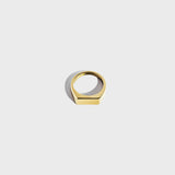 Gold rectangular signet ring on white background