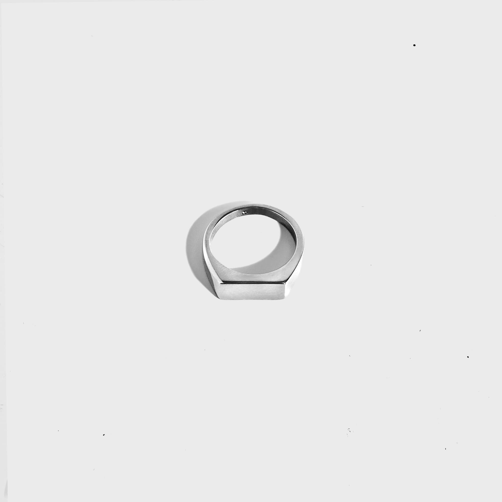 Silver rectangular signet ring on white background