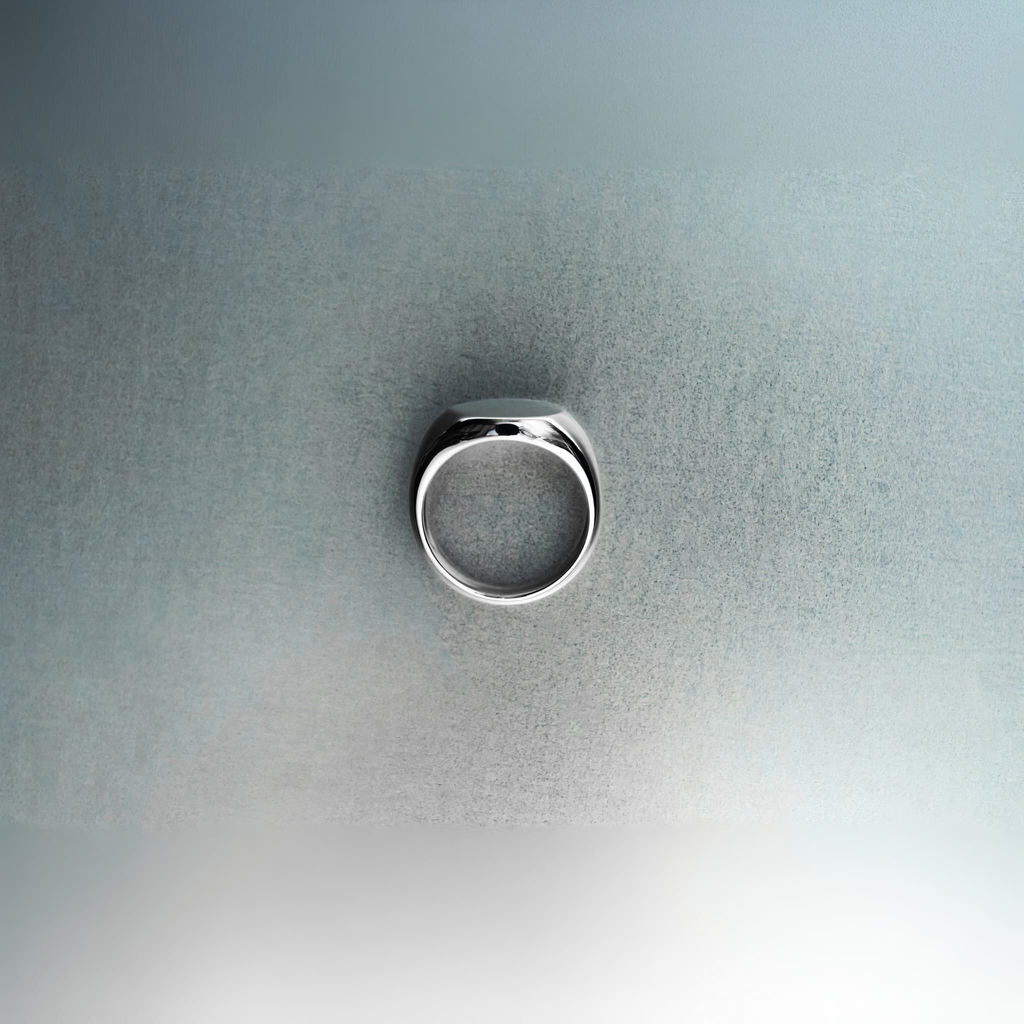 Silver ring on a textured gray surface