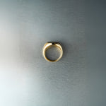 Gold ring on a textured gray background