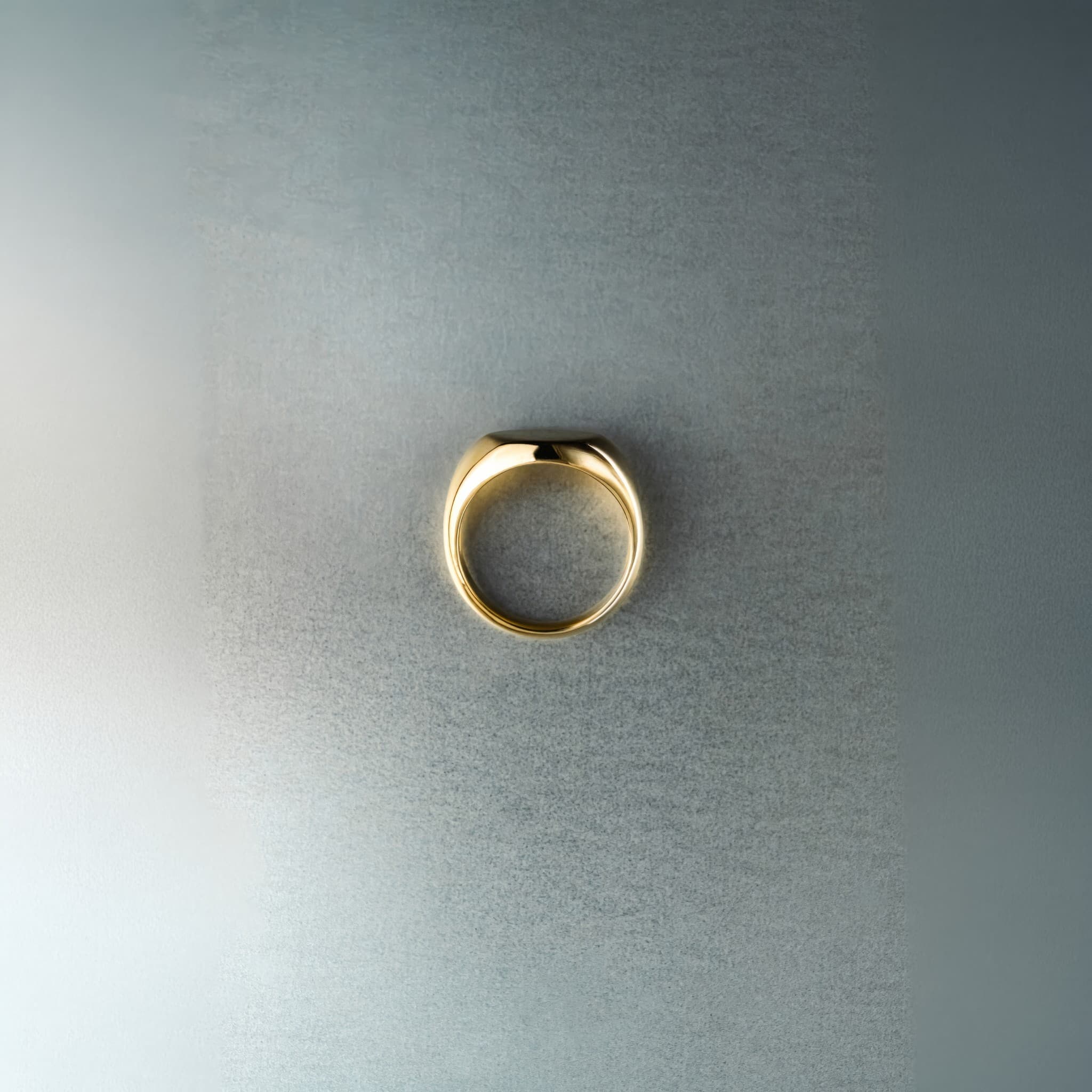 Gold ring on a textured gray background