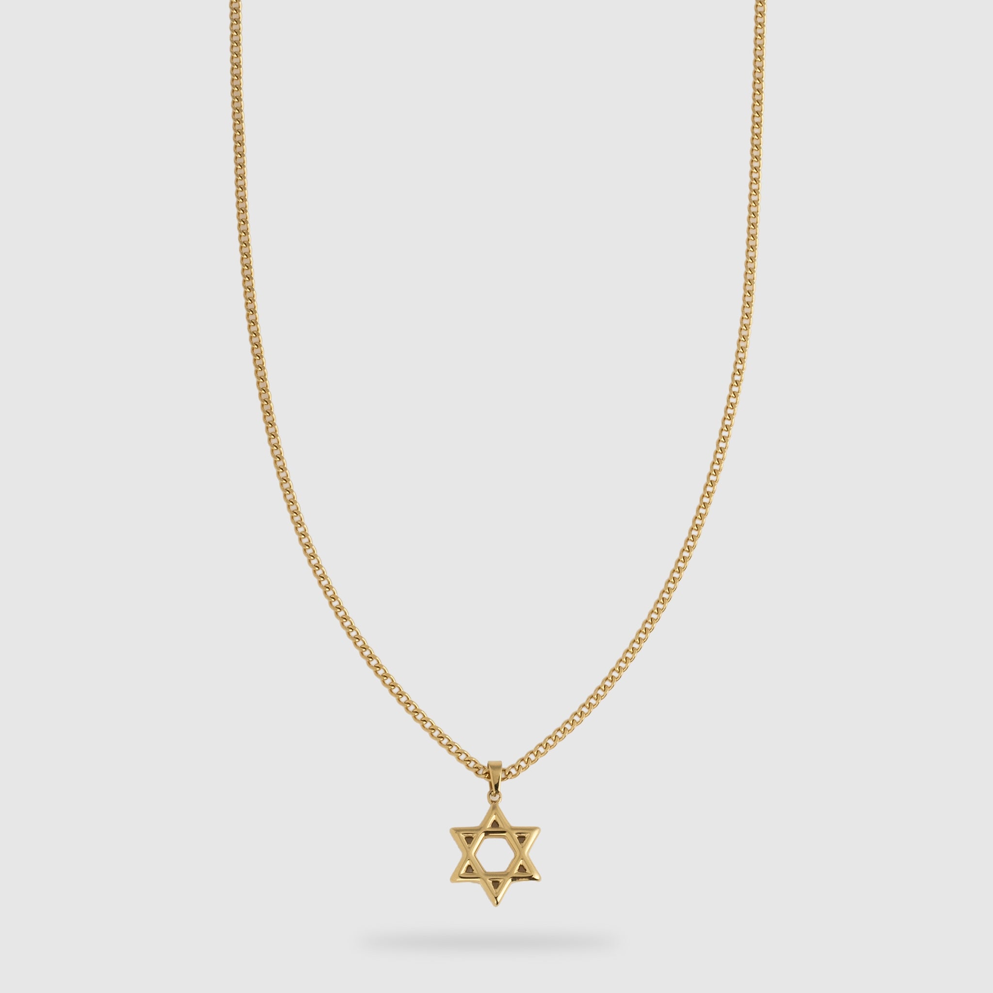 A gold Star of David pendant necklace on a delicate gold cable chain, shown against a light gray background.